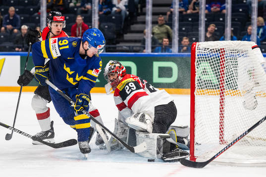 Carl Grundström of Sweden and goaltender Bernhard