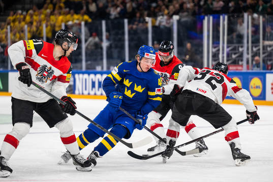 Lukas Haudum and Bernd Wolf of Austria defend against