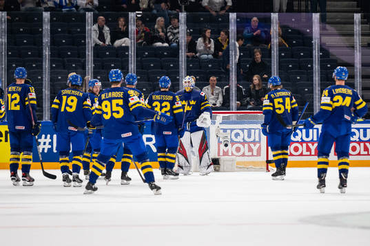 Players of Sweden celebrate with goaltender Jesper Wallstedt
