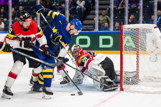 Nico Brunner and goaltender Bernhard Starkbaum of Austria