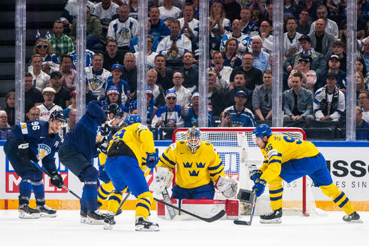 Goaltender Lars Johansson and Jacob de la Rose of Sweden