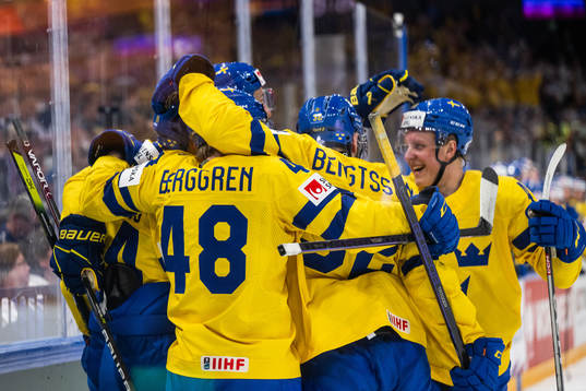 Oscar Lindberg of Sweden celebrates with team mates