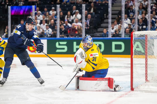 Kaapo Kakko of Finland and goaltender Lars Johansson of