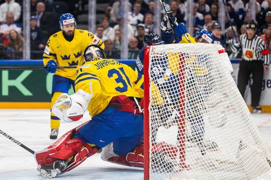 Juho Lammikko of Finland scores 1-1 behind goaltender Lars
