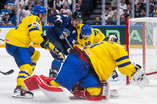 Mikko Rantanen of Finland attacks against Patrik Nemeth,