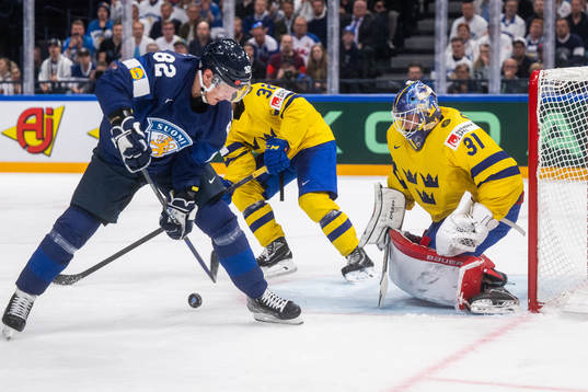 Harri Pesonen of Finland and goaltender Lars Johansson of