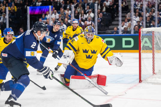 Ville Pokka of Finland and goaltender Lars Johansson of