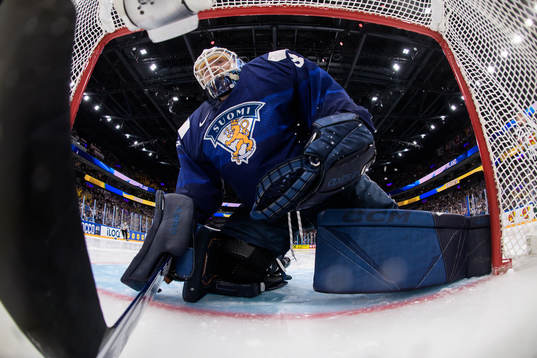 Goaltender Emil Larmi of Finland looks dejected