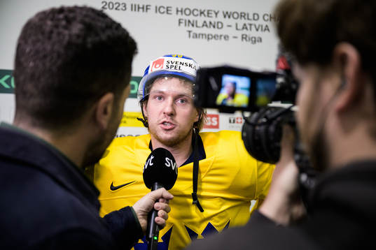 Rasmus Sandin of Sweden being interviewed at a practice