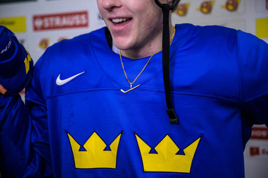 Jonatan Berggren of Sweden with a hockey stick necklace at
