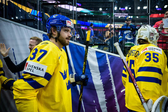 Timothy Liljegren and goaltender Jacob Johansson of Sweden