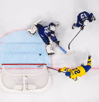 Lucas Raymond of Sweden challenges goaltender Quentin