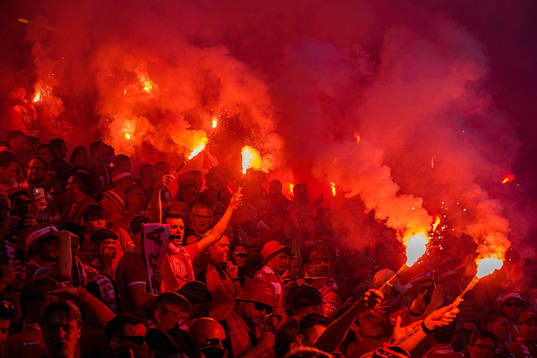 Spectators with flares in the stands