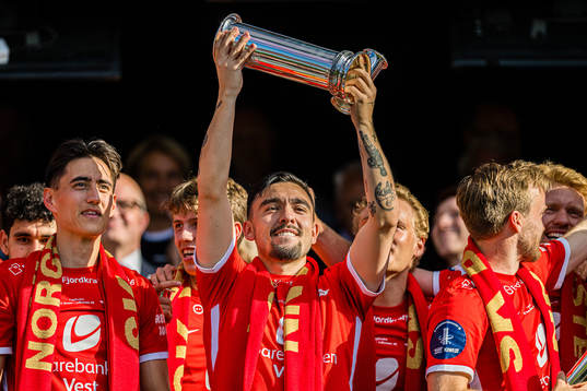 Niklas Castro of Brann celebrates with the trophy