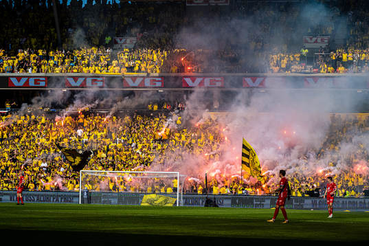Spectators with flares in the stands