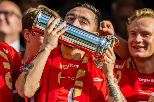 Niklas Castro of Brann celebrates with the trophy
