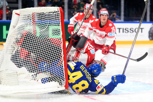 Jonatan Berggren of Sweden crashes into goaltender George