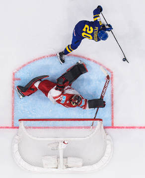 Goaltender George Sørensen of Denmark is being challenged