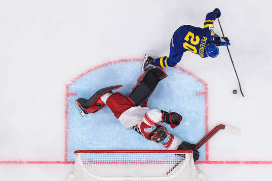Goaltender George Sørensen of Denmark is being challenged