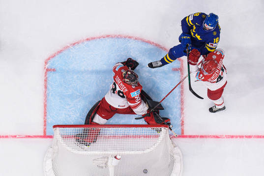 Dennis Everberg of Sweden scores 1-1 behind goaltender