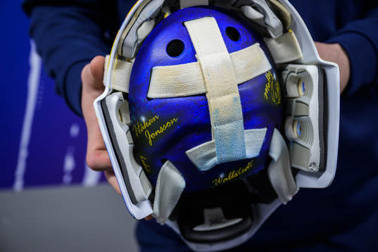 Goaltender Jesper Wallstedt of Sweden holds his helmet