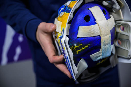 Goaltender Jesper Wallstedt of Sweden holds his helmet