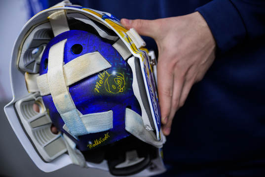 Goaltender Jesper Wallstedt of Sweden holds his helmet