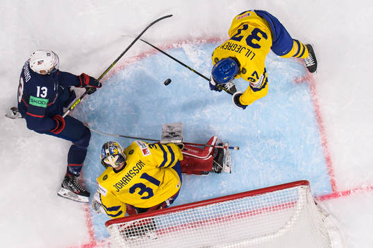 Nick Bonino of USA challenges goaltender Lars Johansson and