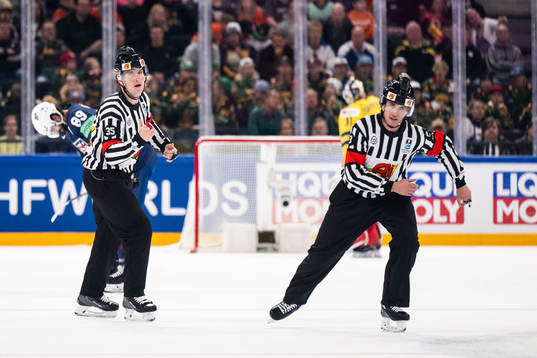 Referees Andre Schrader and Mike Langin
