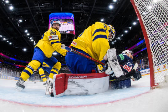 Lukas Bengtsson and goaltender Lars Johansson of Sweden are