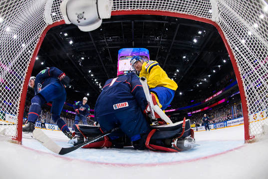 Carl Grundström of Sweden crashes into goaltender Casey