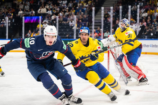 Drew O'Connor of USA against Patrik Nemeth and goaltender