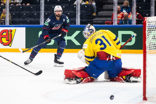 Alex Tuch of USA against goaltender Lars Johansson of Sweden