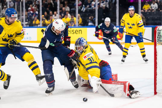 T.J. Tynan of USA and goaltender Lars Johansson of Sweden