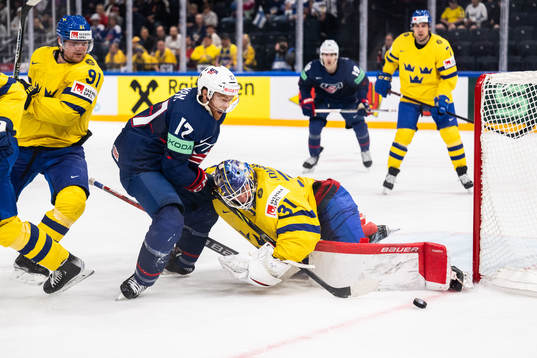 T.J. Tynan of USA and goaltender Lars Johansson of Sweden