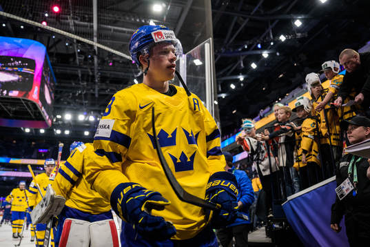 Lucas Raymond of Sweden looks dejected as he leaves the ice