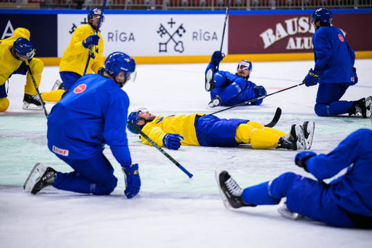 Christian Folin of Sweden leads a stretching exercise at a