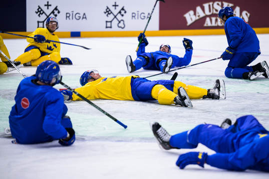 Christian Folin of Sweden leads a stretching exercise at a