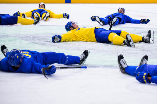 Christian Folin of Sweden leads a stretching exercise at a