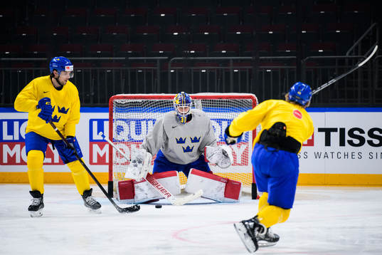 Henrik Tömmernes and goaltender Lars Johansson of Sweden