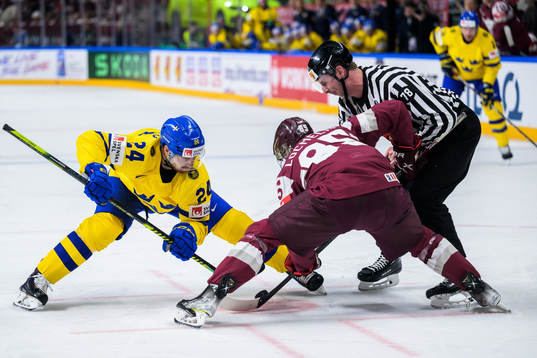 Oscar Lindberg of Sweden face-off with Dans Locmelis of