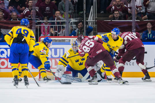 Dans Locmelis of Latvia scores 0-1 behind goaltender Lars