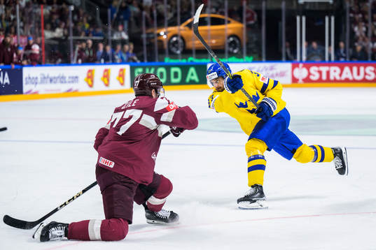 Timothy Liljegren of Sweden scores 1-1 behind goaltender