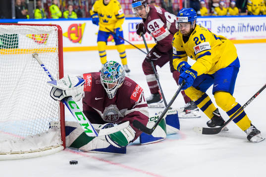 Goaltender Arturs Silovs of Latvia and Oscar Lindberg of
