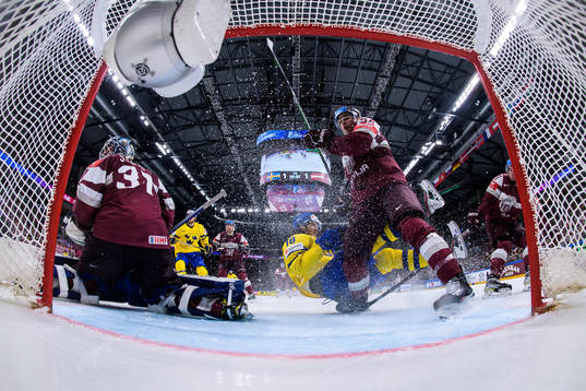 Goaltender Arturs Silovs and Kristians Rubins of Latvia are