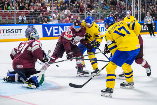 goaltender Arturs Silovs and Kristians Rubins of Latvia
