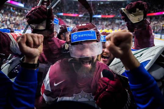 Kaspars Daugavins of Latvia celebrates with team mates
