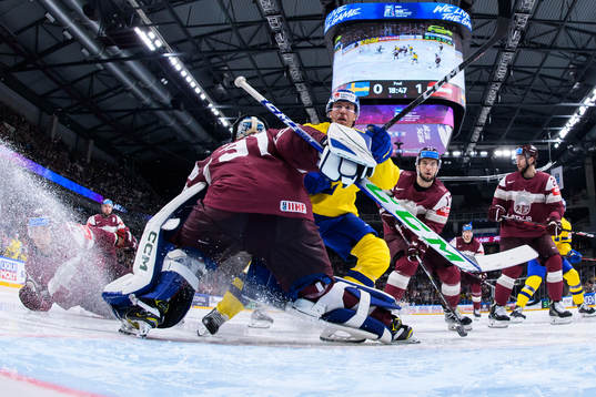 Goaltender Arturs Silovs of Latvia and Pär Lindholm of