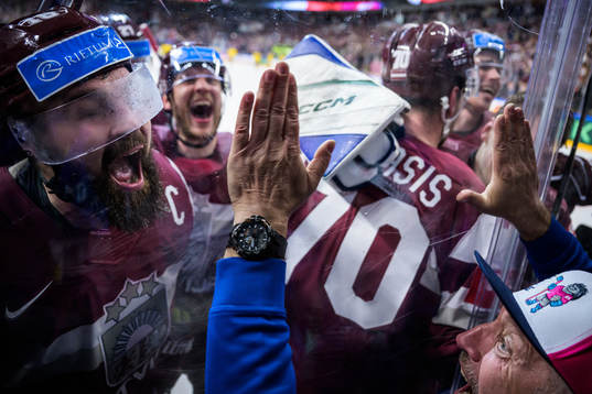 Rodrigo Abols of Latvia and a volunteer celebrate