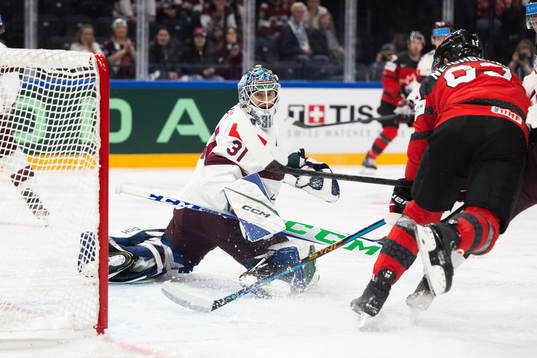 Goaltender Arturs Silovs of Latvia against Jake Neighbours